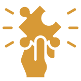 Hand holding a puzzle piece fitting into a puzzle with light rays around it.